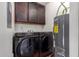 Laundry room with washer, dryer, cabinets and water heater at 1976 N Lemon Tree Ln # 16, Chandler, AZ 85224