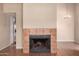 Living room showcasing a cozy fireplace with tile surround and decorative chandelier at 1976 N Lemon Tree Ln # 16, Chandler, AZ 85224
