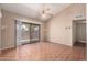 Bright living room featuring ceramic tile flooring, vaulted ceilings, and sliding glass door for natural light at 1976 N Lemon Tree Ln # 16, Chandler, AZ 85224