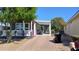 Charming home featuring a covered entry, red front door and a brick driveway at 201 S Greenfield Rd # 215, Mesa, AZ 85206