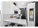 Stylish kitchen offering a sleek design with white cabinets, black accents, and stainless steel appliances at 201 S Greenfield Rd # 215, Mesa, AZ 85206