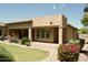 A tan home with a covered patio overlooks a nicely landscaped backyard at 20243 E Poco Calle --, Queen Creek, AZ 85142