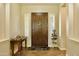 Elegant entryway with a dark wood door, white plantation shutters, and decorative accents on a tiled floor at 20243 E Poco Calle --, Queen Creek, AZ 85142