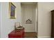 Bright hallway with decorative table featuring art and décor, with arched entryway and tile flooring at 20243 E Poco Calle --, Queen Creek, AZ 85142