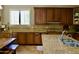 Bright kitchen featuring granite countertops, tile backsplash, stainless steel sink, and ample wooden cabinetry at 20243 E Poco Calle --, Queen Creek, AZ 85142