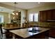 Gourmet kitchen with granite countertops, a large island, and dark wood cabinetry at 20243 E Poco Calle --, Queen Creek, AZ 85142