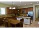 Spacious kitchen showcasing an island with a sink, stainless steel appliances, granite counters, and a dining area at 20243 E Poco Calle --, Queen Creek, AZ 85142