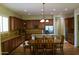 Open kitchen design with a center island, stainless steel refrigerator and appliances, and a breakfast table at 20243 E Poco Calle --, Queen Creek, AZ 85142