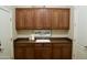 Laundry room features cabinetry and deep utility sink at 20243 E Poco Calle --, Queen Creek, AZ 85142