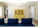 Interior view of a living room with a blue sectional sofa and bright yellow hutch at 20243 E Poco Calle --, Queen Creek, AZ 85142