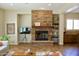 Bright living room featuring a stone fireplace with shelving, comfortable seating, and stylish interior design at 20243 E Poco Calle --, Queen Creek, AZ 85142