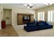 Spacious living room with a sectional couch, decorative ceiling fan, and a sliding barn door media center at 20243 E Poco Calle --, Queen Creek, AZ 85142