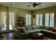 Inviting living room with a large sectional, access to the patio, plantation shutters, and elegant décor at 20243 E Poco Calle --, Queen Creek, AZ 85142