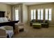 Spacious main bedroom with sitting area including a sofa, chairs, natural light, and carpeted floor at 20243 E Poco Calle --, Queen Creek, AZ 85142