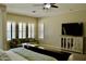 Bright main bedroom with carpet, ceiling fan, large windows, and a comfortable seating area at 20243 E Poco Calle --, Queen Creek, AZ 85142