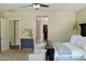 Bright main bedroom with carpet, ceiling fan, walk-in closet, and view of the main bath at 20243 E Poco Calle --, Queen Creek, AZ 85142