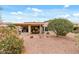 Expansive backyard featuring a covered patio and desert landscaping, perfect for outdoor enjoyment at 20450 N Shadow Mountain Dr, Surprise, AZ 85374