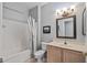 Bathroom featuring a shower and bath, vanity, and framed mirror at 20450 N Shadow Mountain Dr, Surprise, AZ 85374