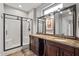 Bathroom features a double vanity, granite countertops, and a glass-enclosed shower at 20450 N Shadow Mountain Dr, Surprise, AZ 85374