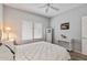 Bedroom with window, console table, ceiling fan and wood floors at 20450 N Shadow Mountain Dr, Surprise, AZ 85374