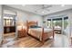 Bright bedroom features wood floors, large windows, and an ensuite bathroom at 20450 N Shadow Mountain Dr, Surprise, AZ 85374