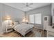 Cozy bedroom featuring a white bed, ceiling fan, wood floors, and a bright window at 20450 N Shadow Mountain Dr, Surprise, AZ 85374