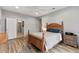 Neutral bedroom features wood floors, a ceiling fan, and access to a bathroom down the hall at 20450 N Shadow Mountain Dr, Surprise, AZ 85374