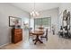Cozy breakfast nook with a round wooden table, chandelier, and bright natural light from the window at 20450 N Shadow Mountain Dr, Surprise, AZ 85374