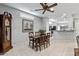 Dining area showcases a wooden table set, tile flooring, and an adjacent kitchen with a breakfast bar at 20450 N Shadow Mountain Dr, Surprise, AZ 85374