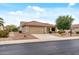A single-story home featuring desert landscaping, a tile roof, and a two-car garage at 20450 N Shadow Mountain Dr, Surprise, AZ 85374