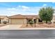 Single-story home with desert landscaping, tile roof, and attached two-car garage in Arizona at 20450 N Shadow Mountain Dr, Surprise, AZ 85374