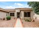 Welcoming front entrance with desert landscaping, a tiled path, and security door at 20450 N Shadow Mountain Dr, Surprise, AZ 85374