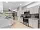 Well-lit kitchen featuring stainless steel appliances, countertops, and tile flooring for a clean and modern aesthetic at 20450 N Shadow Mountain Dr, Surprise, AZ 85374