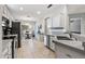 Bright kitchen with stainless steel appliances, tile floors, and breakfast table near a large window at 20450 N Shadow Mountain Dr, Surprise, AZ 85374