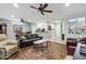 Spacious living room with hardwood floors, comfortable seating, and a seamless connection to the modern kitchen at 20450 N Shadow Mountain Dr, Surprise, AZ 85374