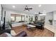 Comfortable living room featuring hardwood floors, a ceiling fan, and access to the backyard at 20450 N Shadow Mountain Dr, Surprise, AZ 85374