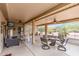 Covered patio with comfortable seating, ceiling fans, and views of the desert landscaping at 20450 N Shadow Mountain Dr, Surprise, AZ 85374