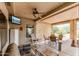 Relaxing covered patio with a ceiling fan, TV, and rocking chair seating area at 20450 N Shadow Mountain Dr, Surprise, AZ 85374