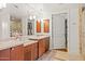 Bathroom with double vanity, mirrors, and views into the walk-in closet and shower at 2402 E Esplanade Ln # 204, Phoenix, AZ 85016