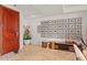 Inviting entryway featuring a solid wood door, travertine tile flooring, and display of framed artwork and decor at 2402 E Esplanade Ln # 204, Phoenix, AZ 85016