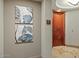 Hallway entrance to apartment with art and wood door at 2402 E Esplanade Ln # 204, Phoenix, AZ 85016