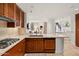 Kitchen featuring stainless steel appliances, wooden cabinets, stone countertops and a breakfast bar at 2402 E Esplanade Ln # 204, Phoenix, AZ 85016
