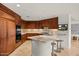 Well-equipped kitchen with wood cabinets, granite counters, bar seating, and modern appliances at 2402 E Esplanade Ln # 204, Phoenix, AZ 85016