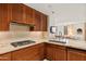 Charming kitchen featuring custom wood cabinetry, tiled backsplash, and granite countertops at 2402 E Esplanade Ln # 204, Phoenix, AZ 85016