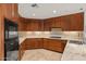 Kitchen featuring wooden cabinetry, subway tile backsplash, stone countertops and stainless steel appliances at 2402 E Esplanade Ln # 204, Phoenix, AZ 85016