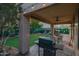 Inviting backyard with a putting green, patio seating, and outdoor kitchen area, perfect for relaxing and entertaining at 29228 N 48Th St, Cave Creek, AZ 85331