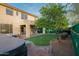 Lush backyard featuring putting green, covered patio, and a charming brick paver patio surrounding the hot tub at 29228 N 48Th St, Cave Creek, AZ 85331