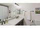 Bathroom vanity with double sinks, dark cabinetry and decorative wall art at 29228 N 48Th St, Cave Creek, AZ 85331