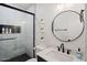 This bathroom has a walk-in shower, dark fixtures, and a round mirror at 29228 N 48Th St, Cave Creek, AZ 85331