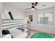 This bedroom features a bunkbed with a ceiling fan, bright lighting, and a green rug at 29228 N 48Th St, Cave Creek, AZ 85331
